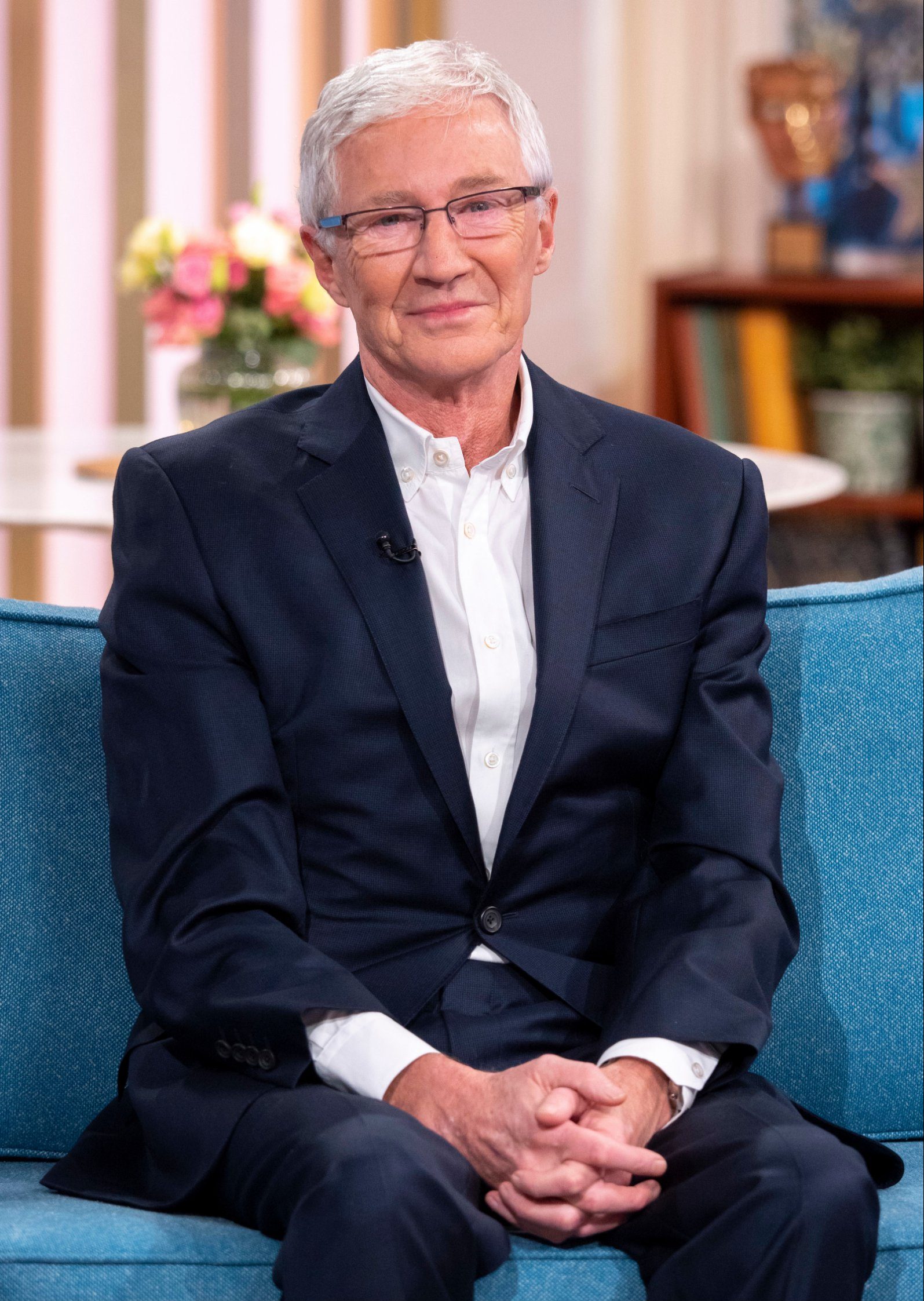 Paul O'Grady sits on the This Morning sofa