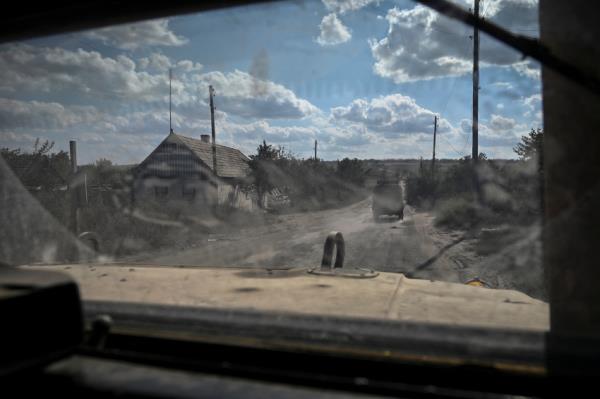 A military vehicle carrying servicemen of Ukraine’s 3rd Separate Assault Brigade drives down a road during a reconnaissance mission near Bakhmut