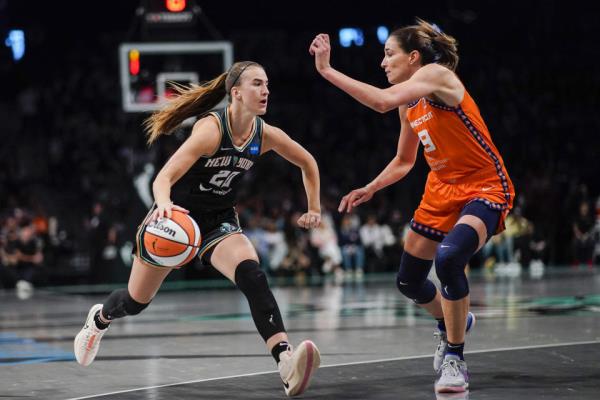 New York Liberty guard Sabrina Ionescu dribbles against Connecticut Sun guard Rebecca Allen during Game 1 of the WNbasemifinals on Sept. 24, 2023, at Barclays Center in New York. (AP Photo/Eduardo Munoz Alvarez)