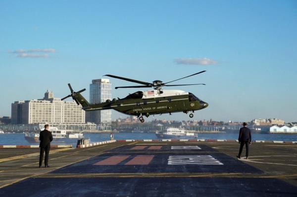 A helicopter carrying White House staff arrives at the Wall Street Landing Zone.