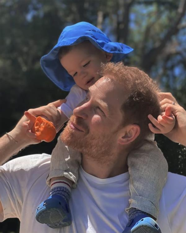 Prince Harry, Duke of Sussex, carrying his eldest child, Prince Archie, in a scene from their Netflix show