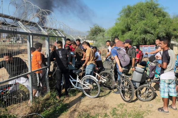 Palestinians from the Gaza Strip enter Kibbutz Kfar Azza on Saturday after Hamas attacked Israeli towns.