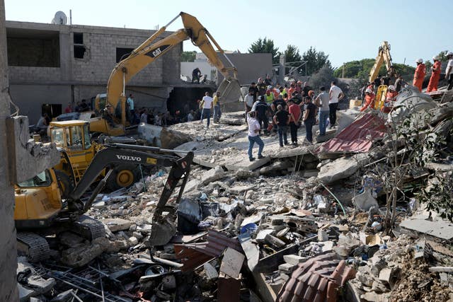 Emergency workers at the scene of an Israeli airstrike in the town of Maisara, north of Beirut