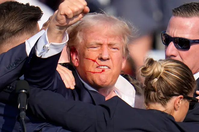 FILE - Republican presidential candidate former President Donald Trump reacts following an assassination attempt at a campaign event in Butler, Pa.