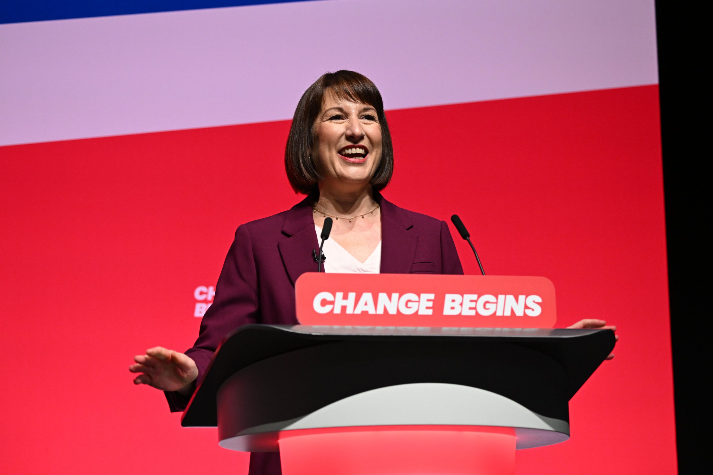 Rachel Reeves is seen standing at a podium 